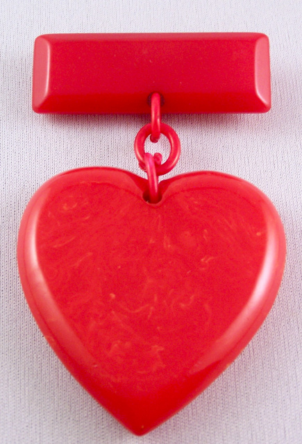 BP110 red bakelite heart/bar pin